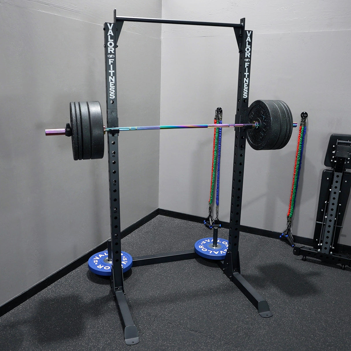 Squat rack with barbell and weight plates in a gym setting