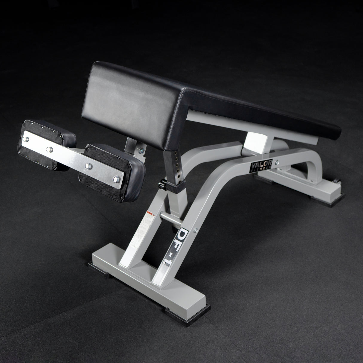 Gym bench with adjustable decline angles on a dark background