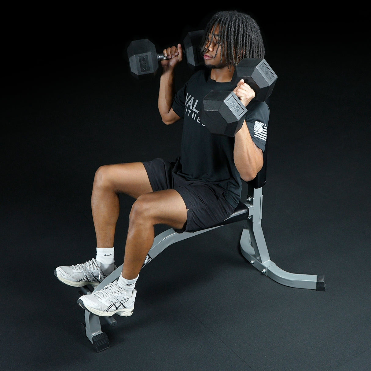 Exercising with dumbbells on a seated straight weight bench