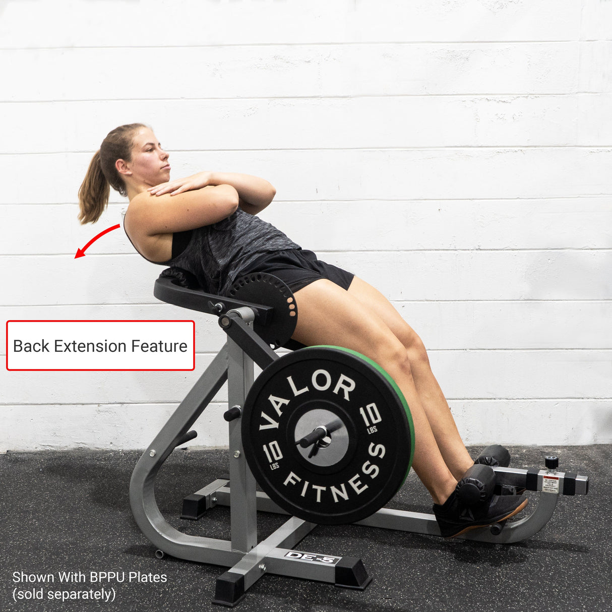 Girl exercising a back extension on a dual-function ab and back workout machine