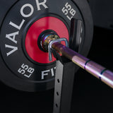 Weight-loaded barbell inside safety locking feature on the top bar holder on a squat rack