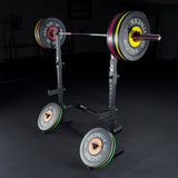 Barbell with weight plates on a squat stand in a gym setting