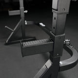 Close up of textured rubberized safety catches on home gym squat and bench rack