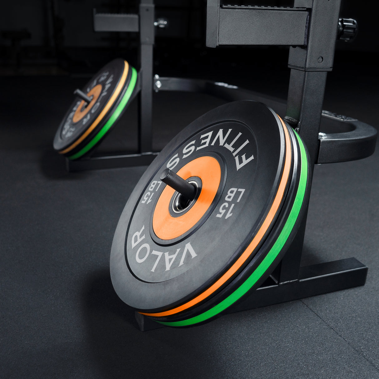 Weight plates stored on a combo squat and bench press rack with built-in plate storage pegs