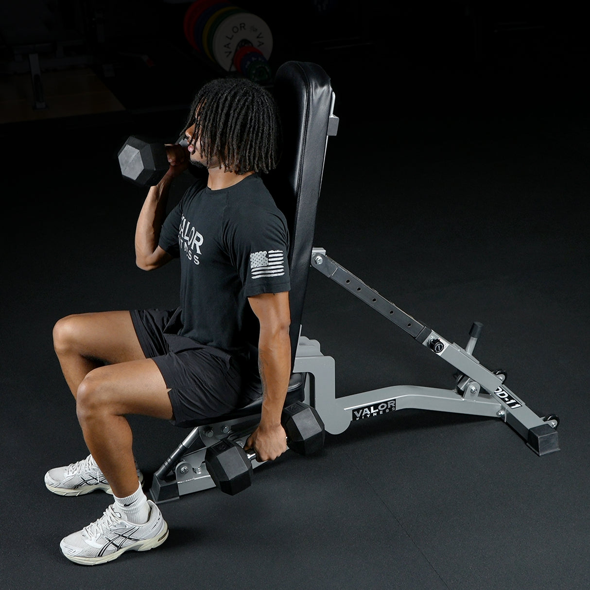 Man doing dumbbell curls on an adjustable weight bench