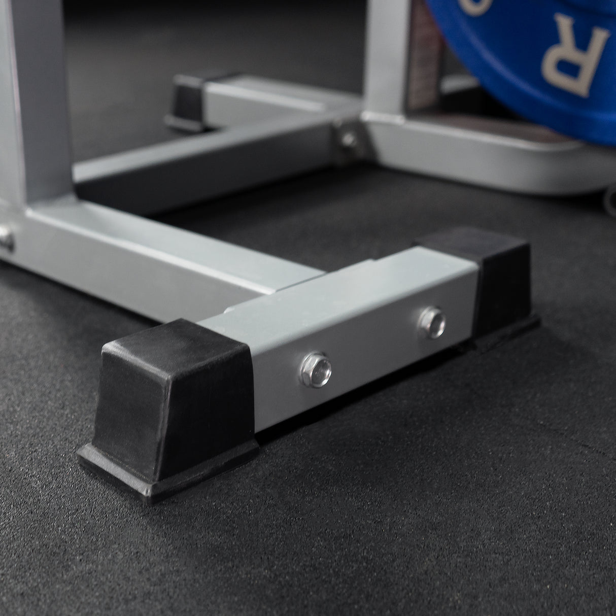 Rubber foot caps on a crunch machine for abs