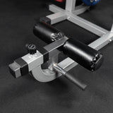 Adjustable calf pad on an ab crunch and back extension machine