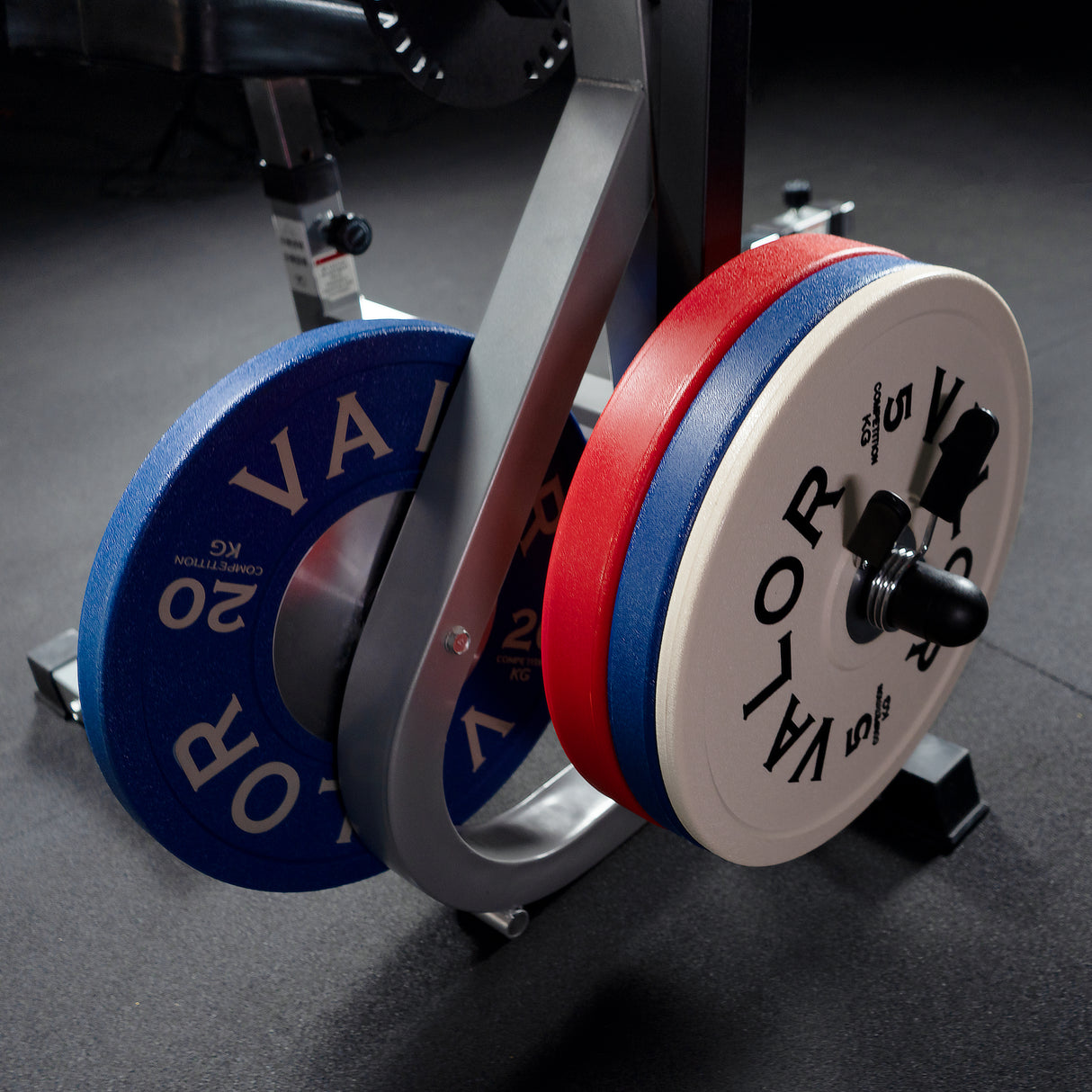 KG Competition Bumper plates on the plate storage of an ab crunch machine