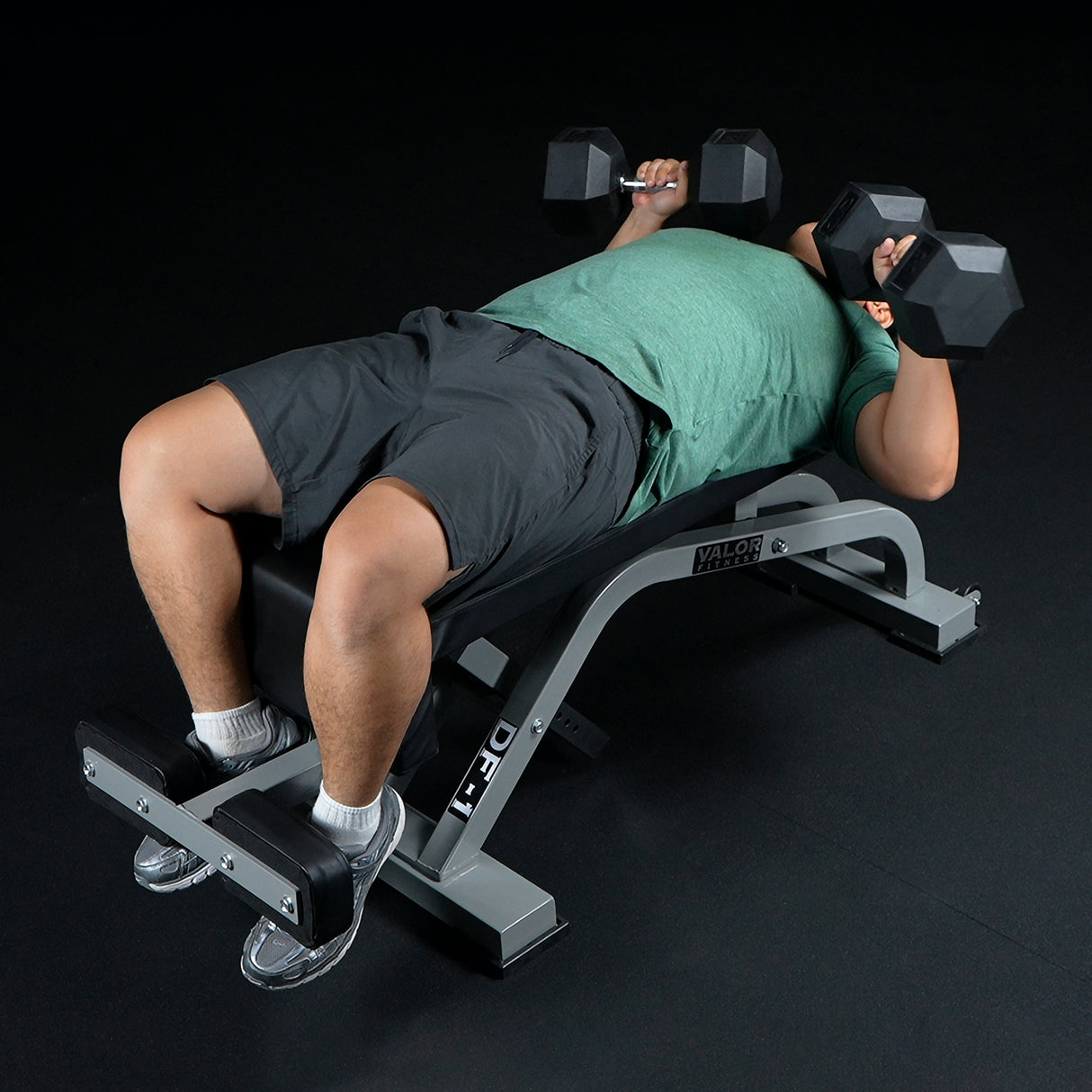 Person performing a bench presses with dumbbells