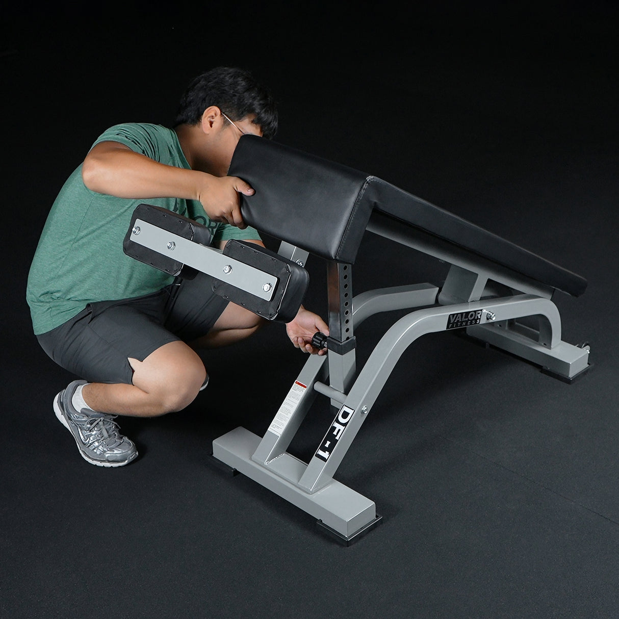 Person adjusting a decline weight bench