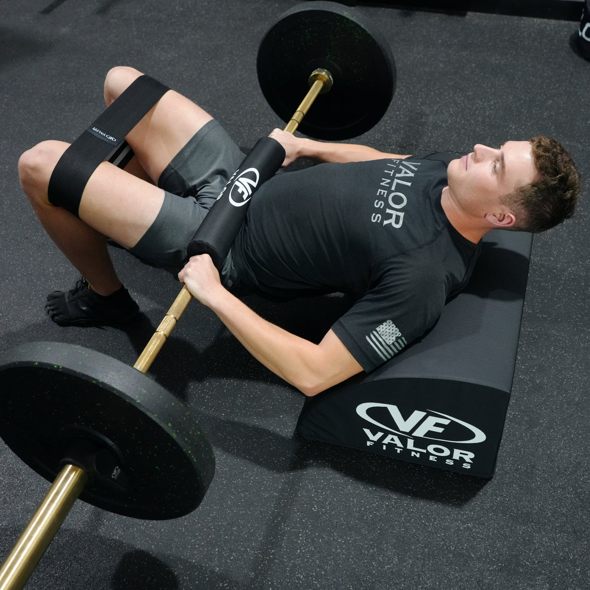 Barbell cushion used for hip thrust exercise with a glute training pad