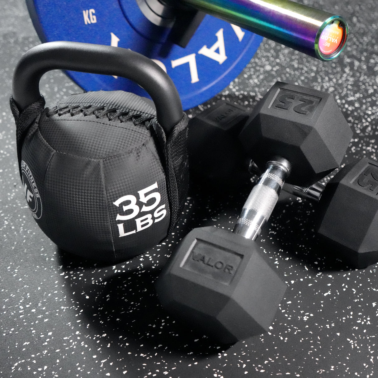 Dumbbell, kettlebell, and weight plate on interlocking puzzle home gym flooring tiles