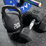 Dumbbell, kettlebell, and weight plate on interlocking puzzle home gym flooring tiles